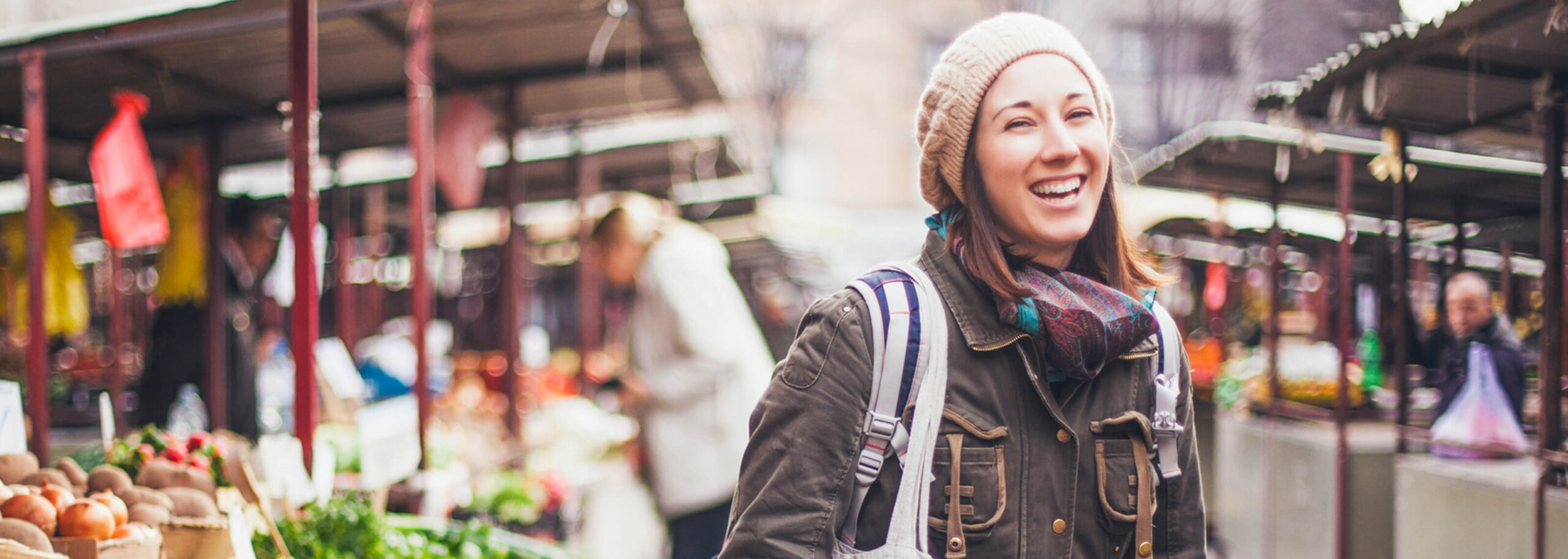 closeup shot of a smiling woman with a hat